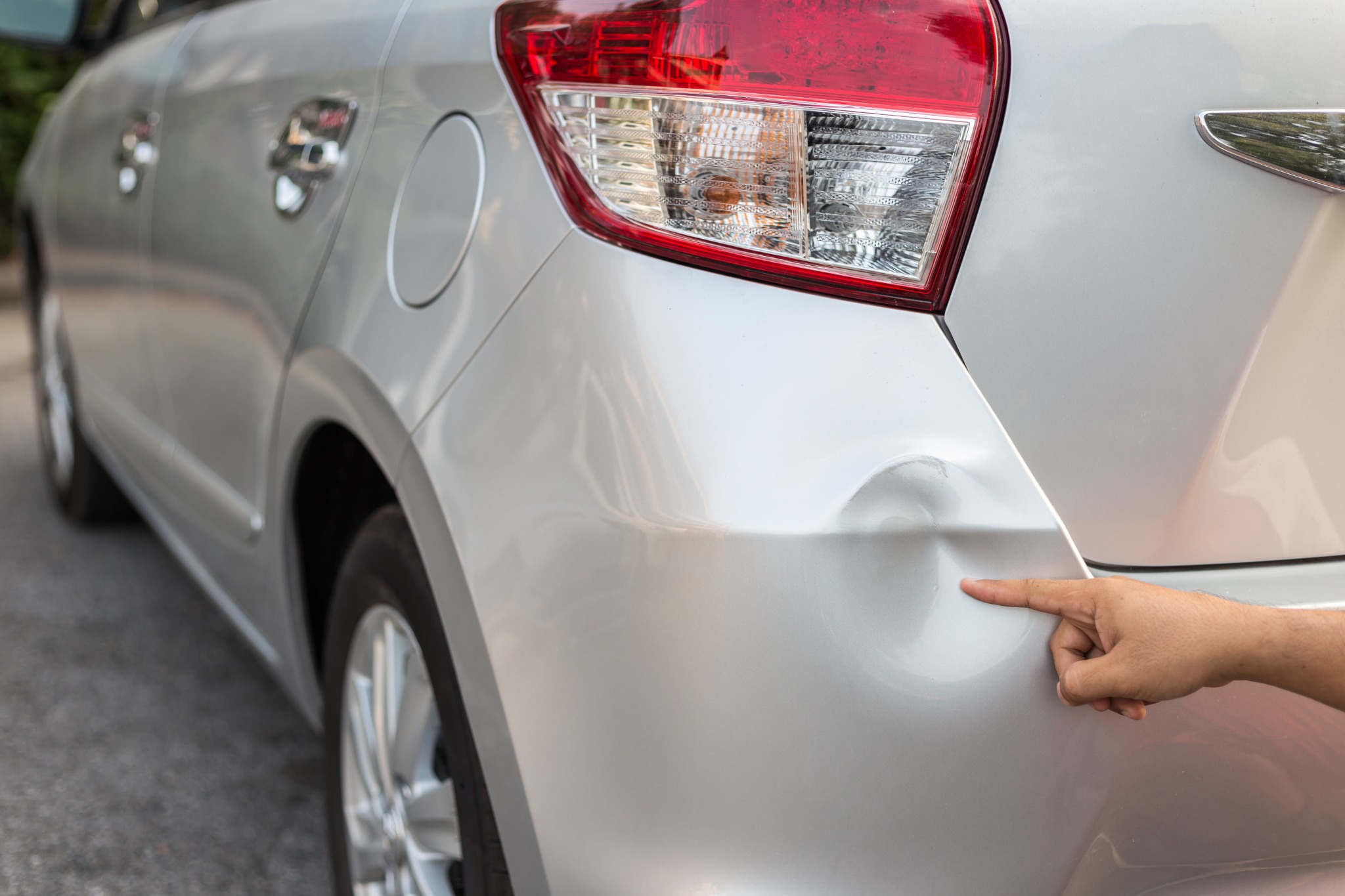 Vehicle with visible body damage, illustrative stock photo